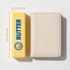 NeeDoh Butter Squishy realistic slow-rise butter stick toy in hand — Image 8 of 12