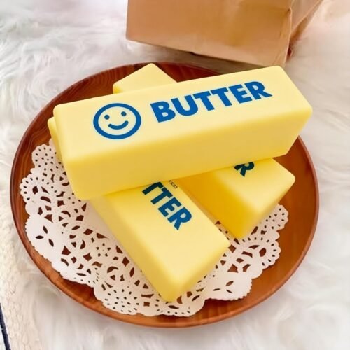 NeeDoh Butter Squishy realistic slow-rise butter stick toy in hand — Image 10 of 12