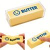 NeeDoh Butter Squishy realistic slow-rise butter stick toy in hand — Image 2 of 12
