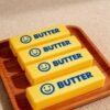 NeeDoh Butter Squishy realistic slow-rise butter stick toy in hand — Image 12 of 12