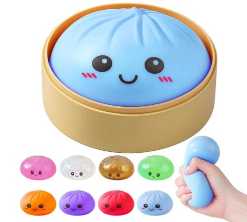 Mystery squishy bao bun toy from NeeDoh inside a bamboo-style steamer basket — Image 1 of 1